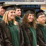 Graduate smiling in cap and gowns